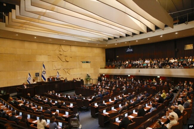 Members of Israel's parliament are being sworn in at the Knesset, the country's legislature, April 30, 2019.