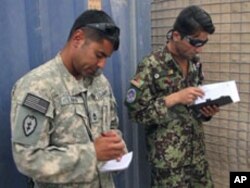 Sergeant First Class David Lara, left, is putting Afghan Air Force flight medics through their paces as he works with Afghan Air Force Sergeant Hayatullah Bahar, Aug 2010