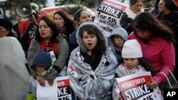 FILE – People protest as part of the National Day of Action to Fight for $15 near a McDonald's restaurant along the Las Vegas Strip in Las Vegas, Nov. 29, 2016. A cluster of Black Lives Matter groups and the organization leading the push for a $15-an-hour wage are joining forces to combine the struggle for racial justice with the fight for economic equality.