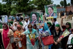 Supporters of Pakistan's jailed ex-Prime Minister Nawaz Sharif gather outside the Adiala jail where he is being held, in Rawalpindi, Pakistan, July 19, 2018.