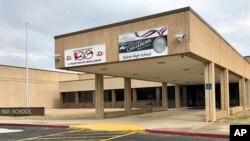 In this Feb. 24, 2018 photo, the main entrance of Dalton High School is shown, in Dalton, Ga. Police in Georgia say a teacher fired a gunshot after locking himself in a classroom. (AP Photo/Jeff Martin)