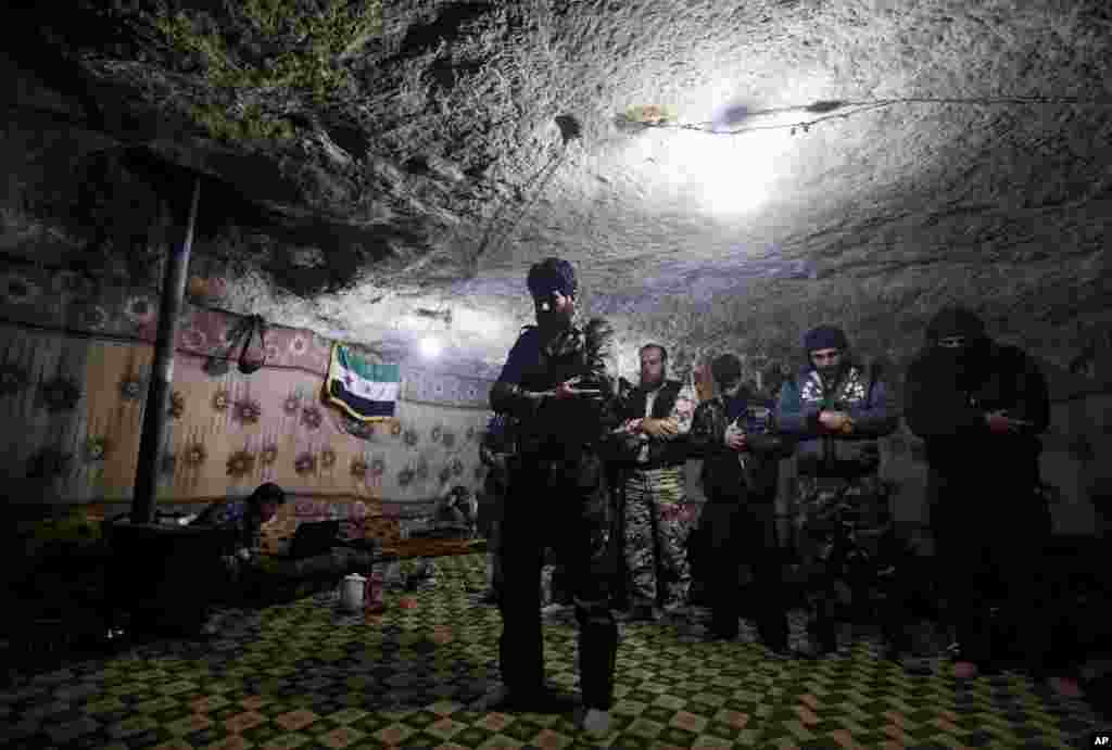 Free Syrian Army fighters pray inside a cave at Jabal al-Zaweya in Idlib, Syria, Feb. 24, 2013. 