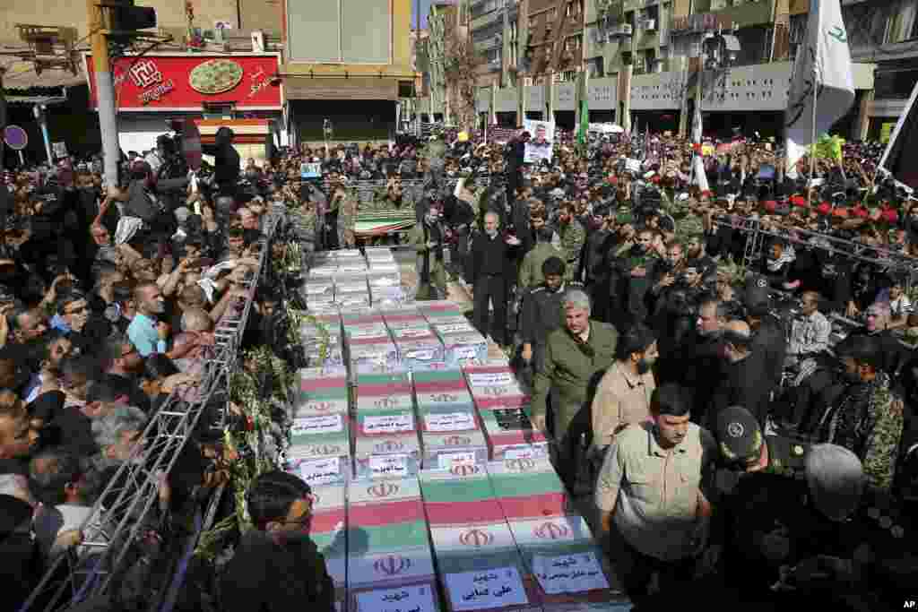 Flags cover the caskets of those who died in Saturday&#39;s terror attack on a military parade in Ahvas, Iran. Thousands of mourners gathered at the Sarallah Mosque on Ahvaz&#39;s Taleghani junction, carrying caskets in the extreme heat.