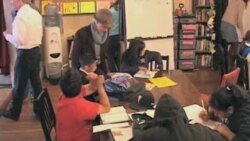 Students write at desks at one of the eight 826 stores.