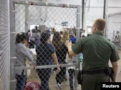 FILE - A view of inside the U.S. Customs and Border Protection (CBP) detention facility shows detainees inside fenced areas at Rio Grande Valley Centralized Processing Center in Rio Grande City, Texas, June 17, 2018.