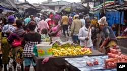 People buy food at a local market in Monrovia, Liberia. The area had been closed off in August because of the Ebola outbreak.