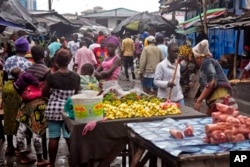 FILE - People buy food at a local market in Monrovia, Liberia.