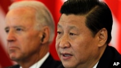 Chinese Vice President Xi Jinping, right, gives an opening statement near U.S. Vice President Joe Biden during talks at a hotel in Beijing, China, Friday, Aug. 19, 2011. (AP Photo/Ng Han Guan, Pool)