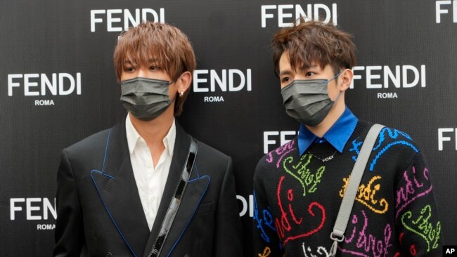 FILE - Keung To, left, and Ian Chan, members of the Cantopop band Mirror, pose for a photo during a promotional event of a luxury store in Hong Kong, July 22, 2021.