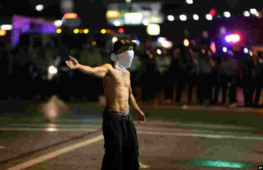 A man stands in the street during a protest for Michael Brown, who was killed by a police officer. Ferguson, Missouri, Aug. 18, 2014