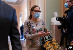 Sen. Kyrsten Sinema, D-Ariz., walks to the chamber after a Senate Democratic Caucus meeting at the Capitol in Washington, Nov. 2, 2021.