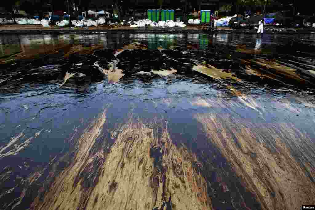 Black oily sludge is seen on sand as cleaning operations continue at Ao Prao Beach on Koh Samet, Rayong, Thailand. An oil spill that has blackened beaches at the holiday island of Koh Samet was having an extreme impact on tourism and could spread&nbsp; to the coast of the mainland and affect the fishing industry, officials and an environmental group said.