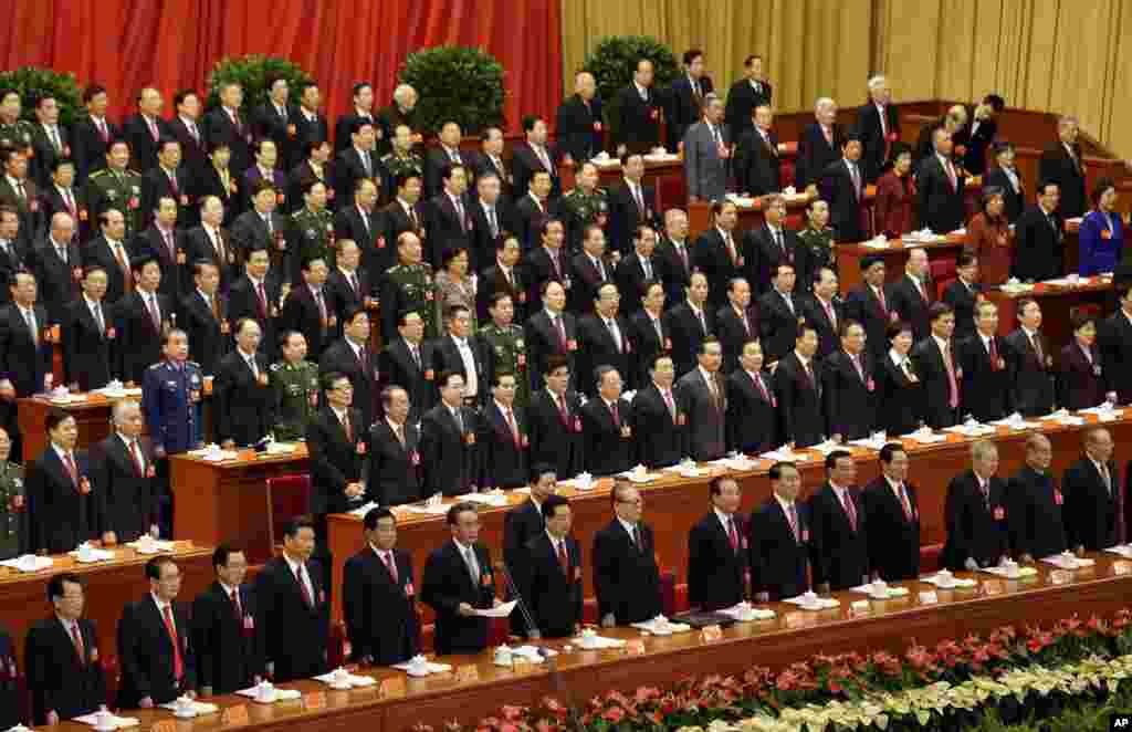 Communist leaders stand before the national anthem during the opening session of the 18th Communist Party Congress at the Great Hall of the People in Beijing, November 8, 2012.