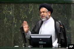 FILE - Iranian Intelligence Minister Mahmoud Alavi answers lawmakers' questions in a session of parliament in Tehran, Iran, Oct. 25, 2016. Alavi said in August that agents "spotted and thwarted more than 1,500 young people who intended to join" IS.