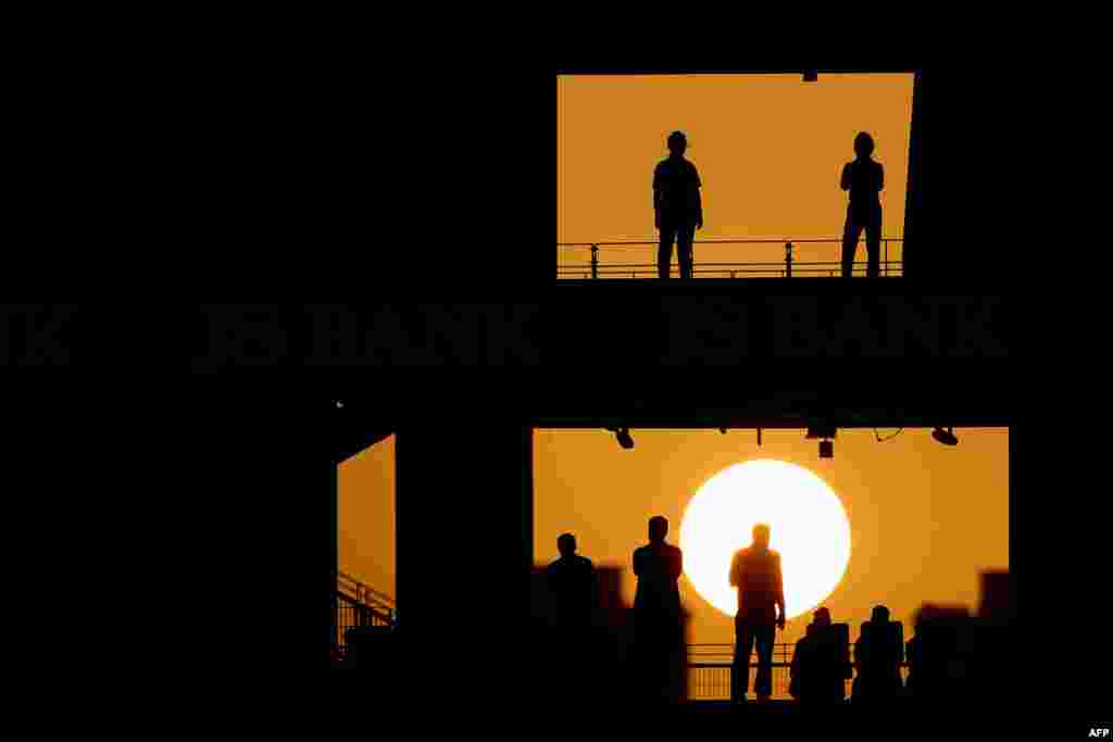 Fans attend the fourth One Day International (ODI) cricket match between Pakistan and Australia at Dubai International Stadium in Dubai, UAE.