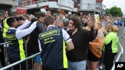 Fans are searched as they arrive for a concert at Old Trafford Cricket Ground in Manchester, England, May 27, 2017. More than 20 people were killed in an explosion following a Ariana Grande concert at the Manchester Arena late Monday evening.