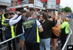 Fans are searched as they arrive for a concert at Old Trafford cricket ground in Manchester, England, May 27 2017. More than 20 people were killed in an explosion following a Ariana Grande concert at the Manchester Arena late Monday evening.