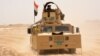 Iraqi government forces drive their armored vehicle, June 22, 2016, some 40 kilometers (25 miles) west of Qayyarah, during their operation to take the city and make it a launchpad for Mosul. 