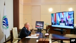 Russian President Vladimir Putin takes part in the Shanghai Cooperation Organization summit in Dushanbe, Tajikistan, via video link from the Novo-Ogaryovo residence outside Moscow, Russia, Sept. 17, 2021.