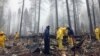 After a brief delay to let a downpour pass, volunteers resume their search for human remains at a mobile home park in Paradise, Calif., Nov. 23, 2018. The team is doing a second search because there are missing people whose last address was the mobile home park.