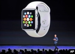 FILE - Apple CEO Tim Cook introduces the new Apple Watch on Tuesday, Sept. 9, 2014, in Cupertino, Calif. Apple's new wearable device marks the company's first major entry in a new product category since the iPad's debut in 2010. (AP Photo/Marcio Jose Sanchez)