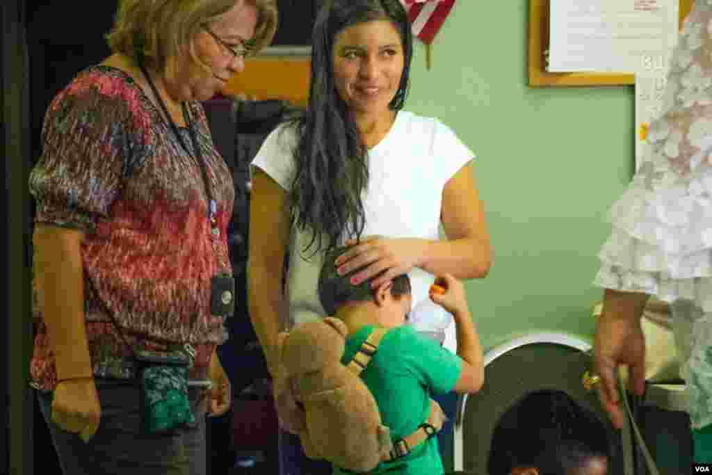 After their release from federal detention, Ana shares a hug with her son at the Holding Institute in Laredo, Texas, Aug. 12, 2014. (VOA / V. Macchi)