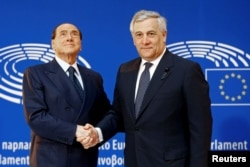 FILE - Italian former Prime Minister Silvio Berlusconi is welcomed by EU Parliament President Antonio Tajani, at the European Parliament in Strasbourg, France, July 1, 2017.