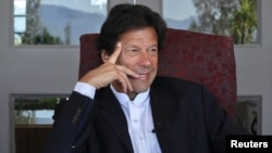 Imran Khan, Pakistani cricketer turned politician, gestures during an interview with at his residence in Islamabad, November 16, 2011.