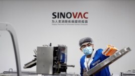 FILE - A man works in the packaging facility of Chinese vaccine maker Sinovac Biotech, developing an experimental coronavirus disease (COVID-19) vaccine, during a government-organized media tour in Beijing, China, September 24, 2020. (REUTERS)