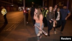 Concert goers react after fleeing the Manchester Arena in northern England where U.S. singer Ariana Grande had been performing in Manchester, Britain, May 22, 2017.