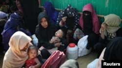 FILE - Rohingya refugee women wait outside of a medical center at Jamtoli camp in Cox's Bazar, Bangladesh, Jan. 22, 2018. 