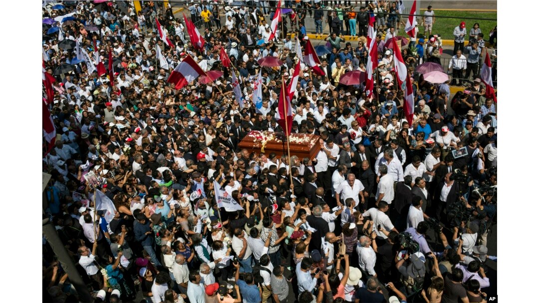 People carry the coffin of Peru's late President Alan Garcia through the street during his funeral procession in Lima, Peru, April 19, 2019.