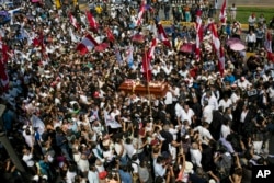 People carry the coffin of Peru's late President Alan Garcia through the street during his funeral procession in Lima, Peru, April 19, 2019.