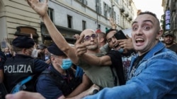 People demonstrate against the introduction of a mandatory sanitary pass called "green pass" in the aim to limit the spread of the Covid-19, at the Piazza Porta Palazzo in central Turin on Sept. 11, 2021.