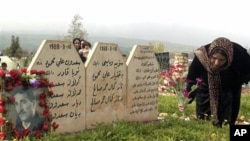 A Kurdish woman places flowers at graves of her loved ones in Halabja, Iraq. (file)