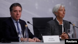 International Monetary Fund Managing Director Christine Lagarde and Argentina's Treasury Minister Nicolas Dujovne attend a news conference in Buenos Aires, Argentina, July 21, 2018. 