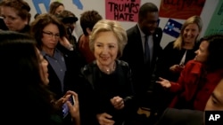 Democratic presidential candidate Hillary Clinton, center, greets supporters as she visits her campaign field office in Oakland, Calif., May 6, 2016. 