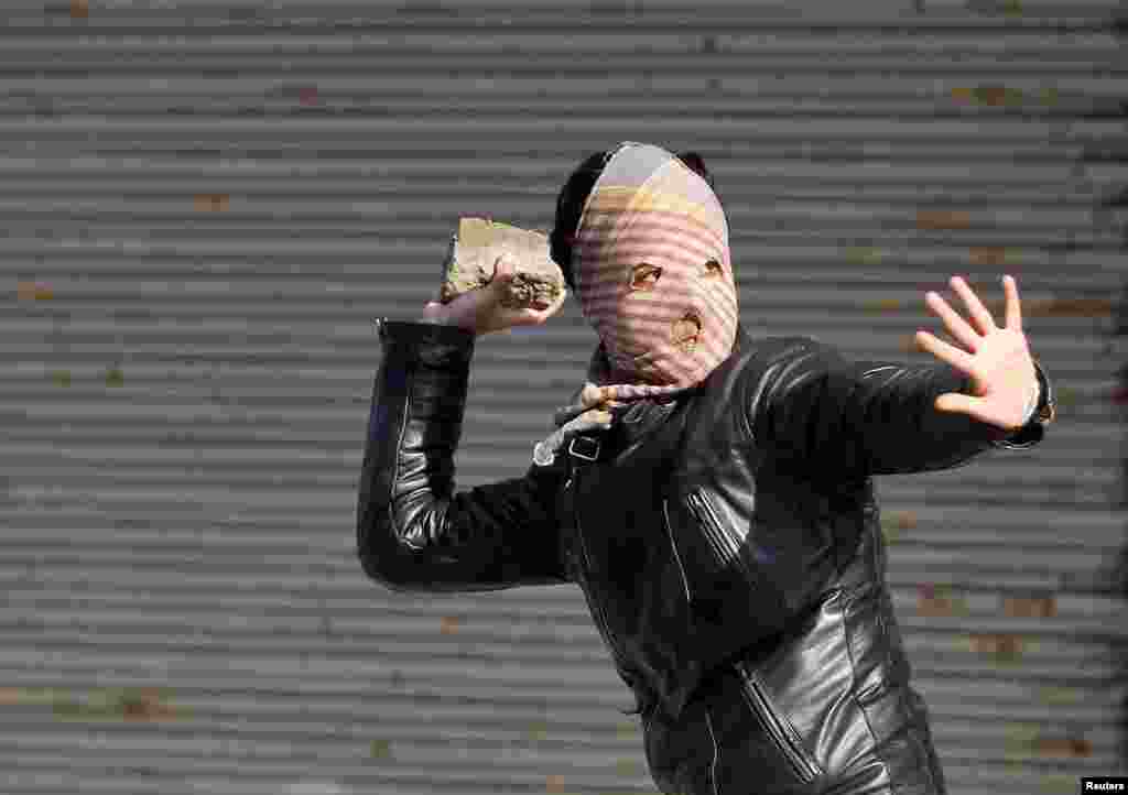 A Kashmiri Muslim demonstrator throws a stone towards Indian police (unseen) during a protest in Srinagar.&nbsp;Clashes between Indian police and Kashmir Muslim demonstrators broke out after a protest which was organized by the Jammu Kashmir Liberation Front (JKLF), a Kashmiri separatist party, to mark the anniversary of the killings of at around 50 people allegedly by Indian security forces during a protest on January 21, 1990, demonstrators said.