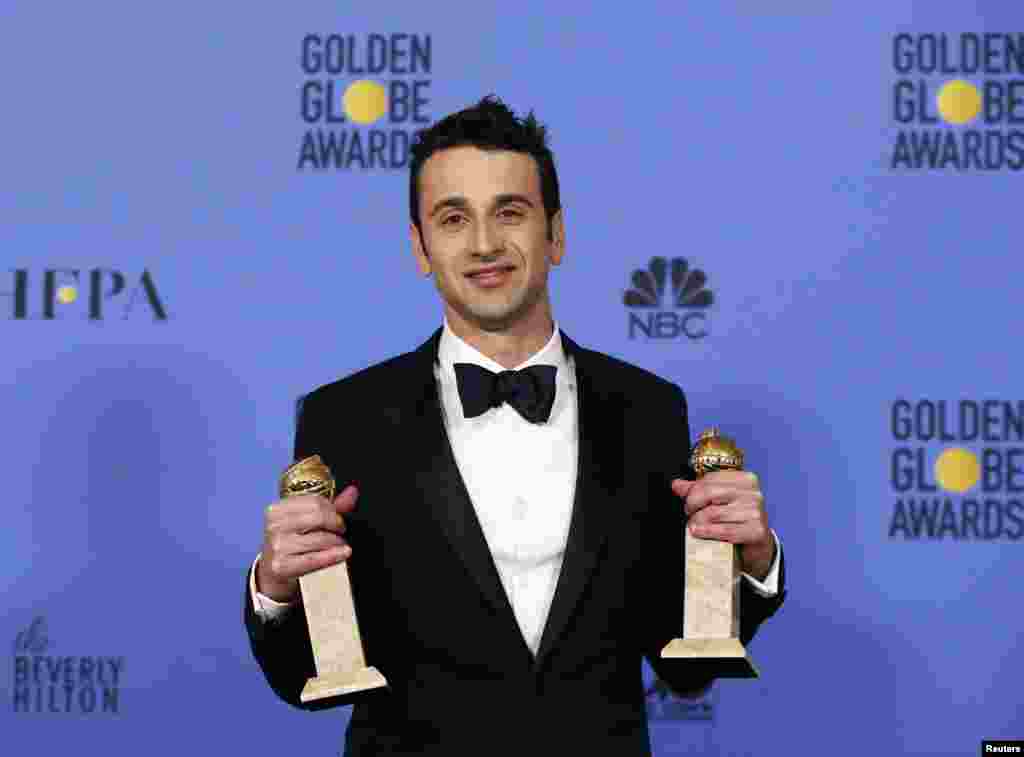Composer Justin Hurwitz holds the awards for Best Original Score for "La La Land" and Best Original Song for "City of Stars" also from "La La Land" at the Golden Globe awards, Jan. 8, 2017.