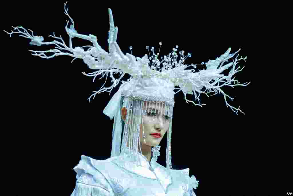 A model displays a creation from a collection by Jingyi Jin during China Fashion Week in Beijing, China.