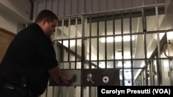 FILE - A security guard secures a gate at the medium security Maryland Correctional Institution in Hagerstown, Maryland. The U.S. Justice Department says it will provide life skills and job training for U.S. prisoners re-entering society.