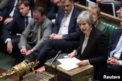 FILE - Prime Minister Theresa May talks about Brexit 'plan B' in Parliament, in London, Britain, Jan. 29, 2019.