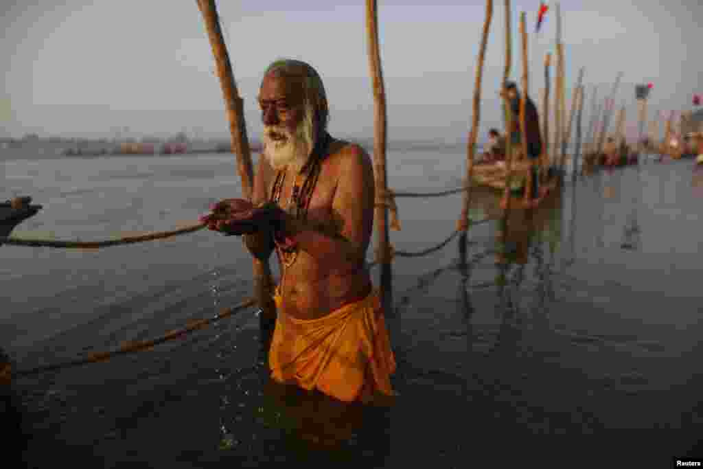 A Hindu devotee prays as he takes a holy dip in the waters of the Ganges River ahead of the &lsquo;Kumbh Mela&rsquo;, or Pitcher Festival, in Allahabad, India.