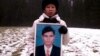 Chea Vichea's wife holding a picture of her late husband, Chea Vichea, file photo. 