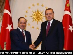 FILE - Turkish President Recep Tayyip Erdogan meets with Masoud Barzani, President of the Iraqi Kurdistan Region in Ankara, Aug. 23, 2016.