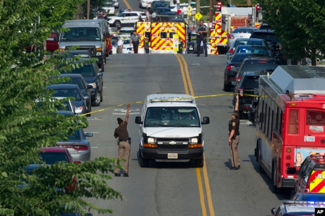 Police and emergency personnel are seen near the scene where House Majority Whip Steve Scalise of La. was shot during a Congressional baseball practice in Alexandria, Virginia, June 14, 2017.
