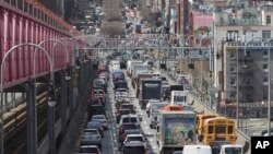 In this March 28, 2019 photo, traffic makes its way into Manhattan from Brooklyn over the Williamsburg Bridge in New York. A congestion toll that would charge drivers to enter New York City's central business district is a first for an American city. (AP Photo/Mary Altaffer)