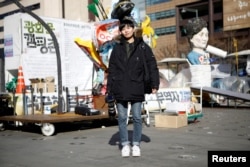 Jeung Un, 27, a freelance photographer, poses for a portrait at a site which protesters have occupied, in central Seoul, South Korea, Feb. 23, 2017.