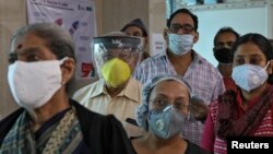 FILE - People wearing protective face masks wait to register their names for a COVID-19 vaccine at a government-run health clinic in Kolkata, India, January 29, 2021. (REUTERS/Rupak De Chowdhuri)