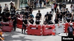  Protesters form up barricades as they block one of the main streets in Hong Kong, June 21, 2019. 